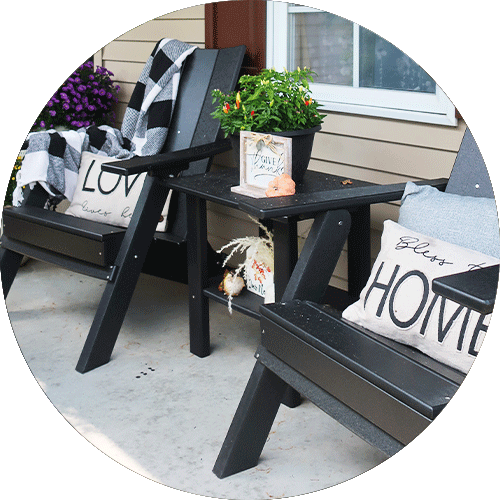 A set of black chairs and a side table.